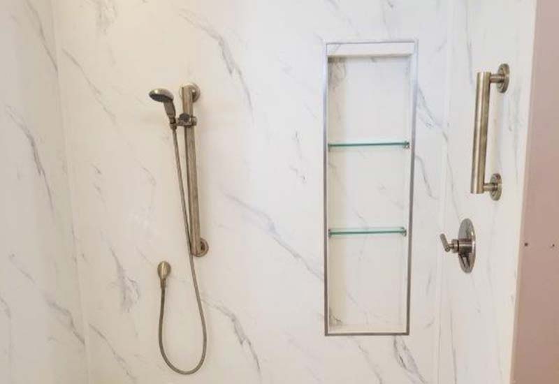 Inside granite shower with gold fixtures