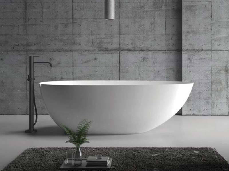 White modern bathtub in gray bathroom