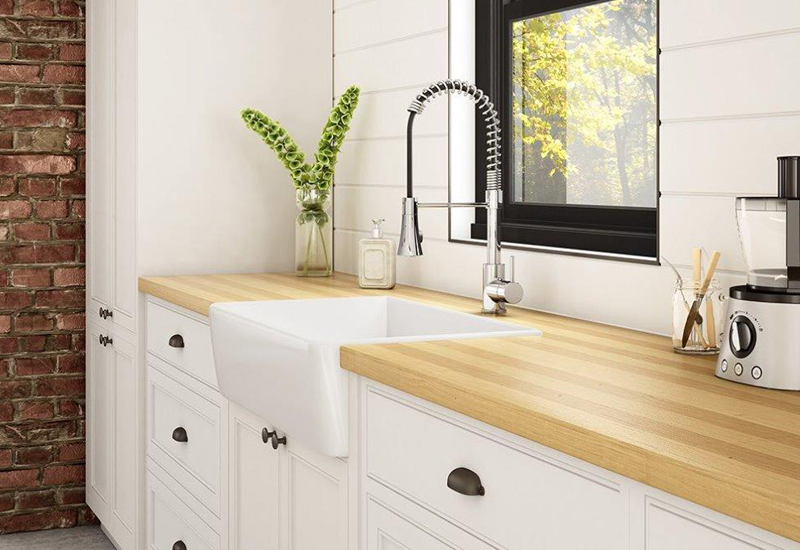 Farmhouse sink in kitchen with butcherblock counter tops